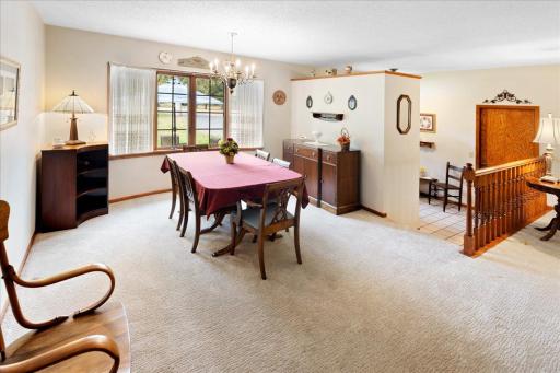 Generously sized formal dining room featuring a large window for natural light and an open layout connecting to the living room.