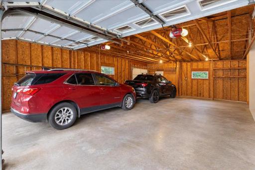 Impressive oversized 3+ car attached garage offering abundant space for vehicles, storage, tools, and hobbies. Features a spacious concrete floor, garage door openers, and plenty of room for a workshop or additional storage.
