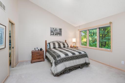 Primary Bedroom with vaulted ceilings & wooded views