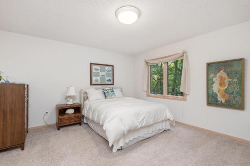 Bedroom 3 with walk-in closet and wooded views