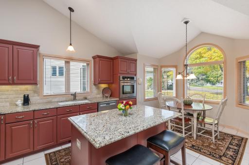 Kitchen features granite countertops & tiled backsplash