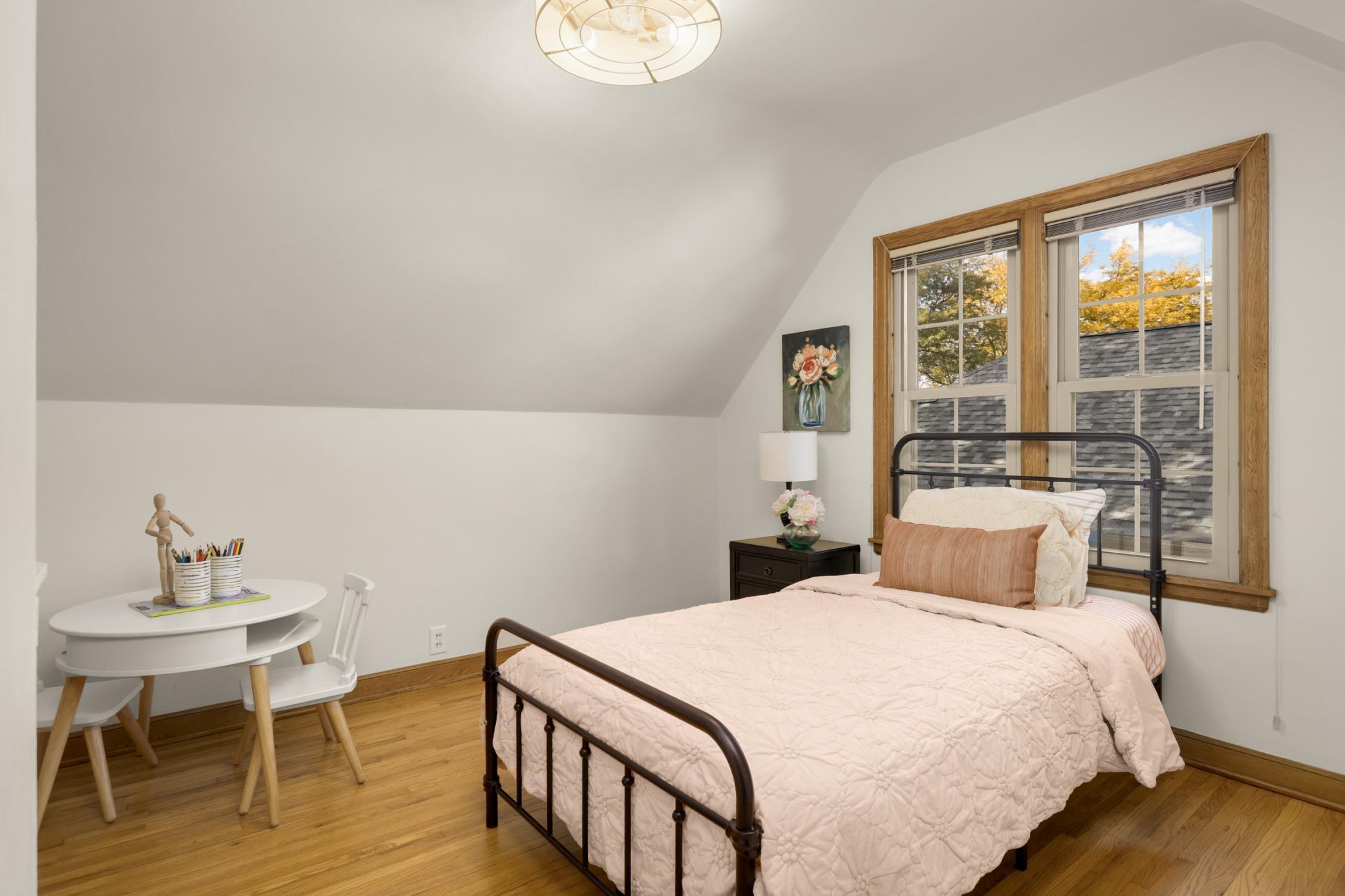 This charming bedroom on the second floor is cozy and inviting.