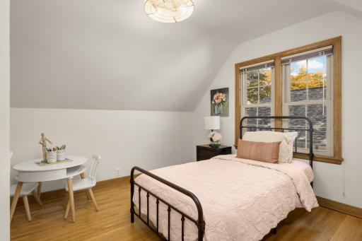 This charming bedroom on the second floor is cozy and inviting.