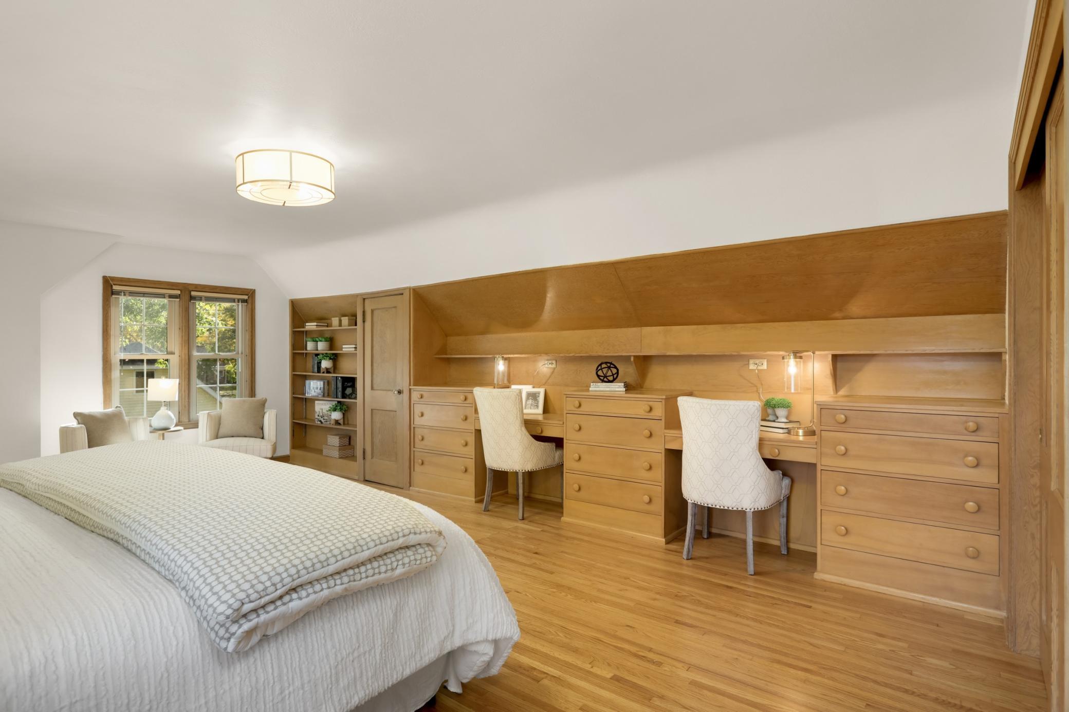 Primary bedroom on the second floor is spacious and bright. Beautiful built-ins include dressers, desks and a book case.