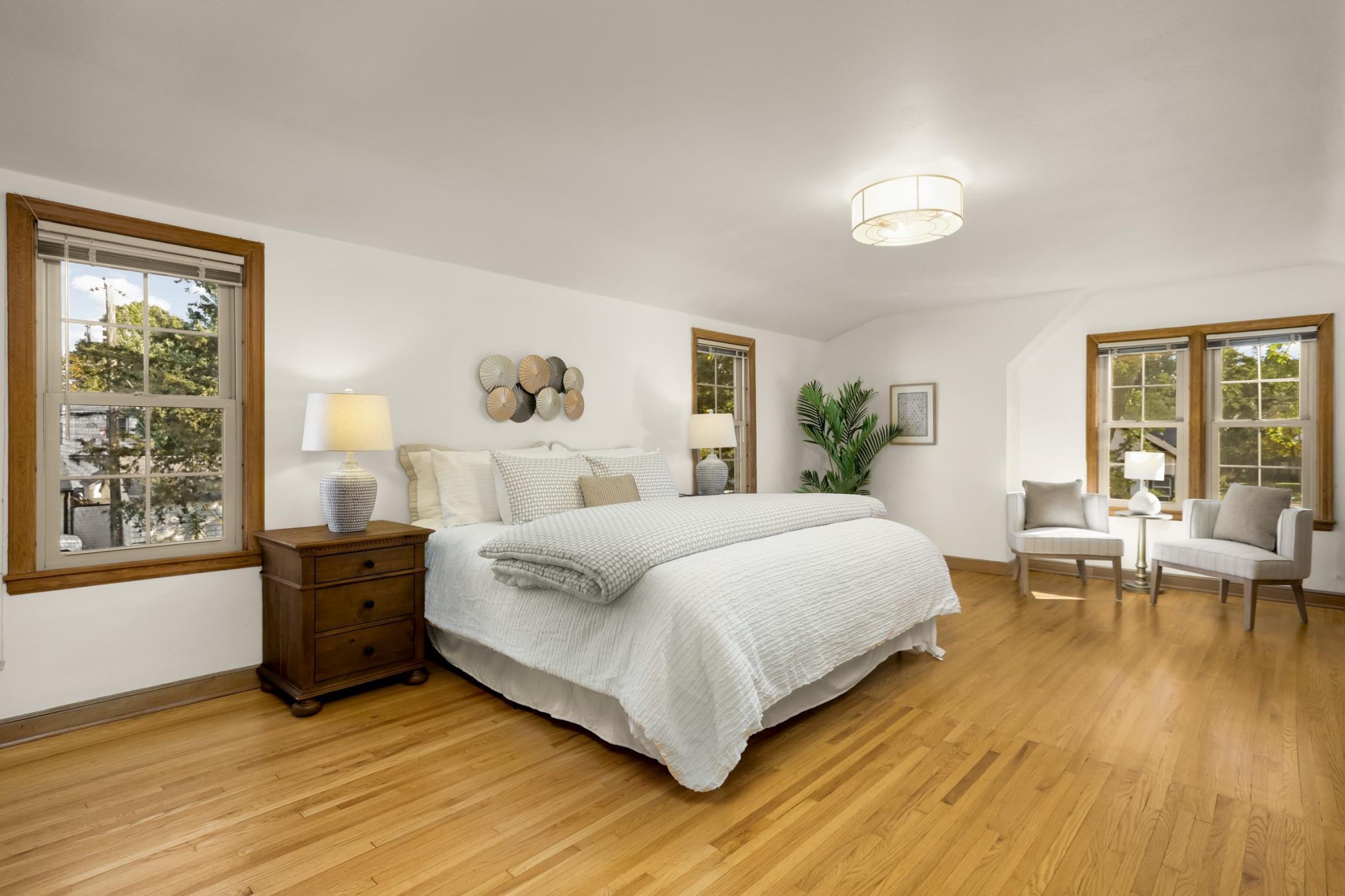 An oasis! Hardwood floors show where the house was expanded which included the addition of the main floor bedroom and the solarium by a previous owner.