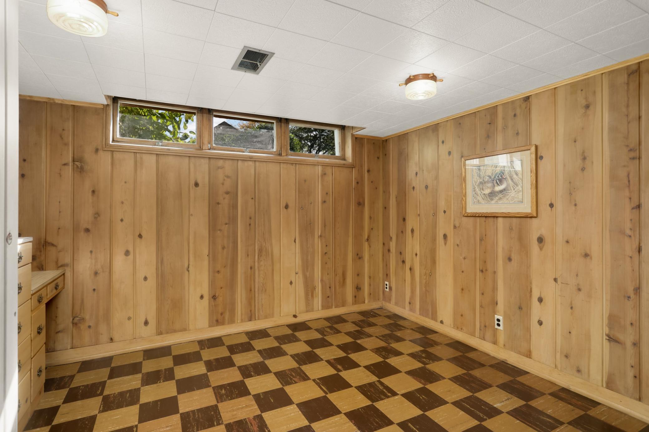 Lower level den has beautiful woodwork, closet and built in dresser and desk.
