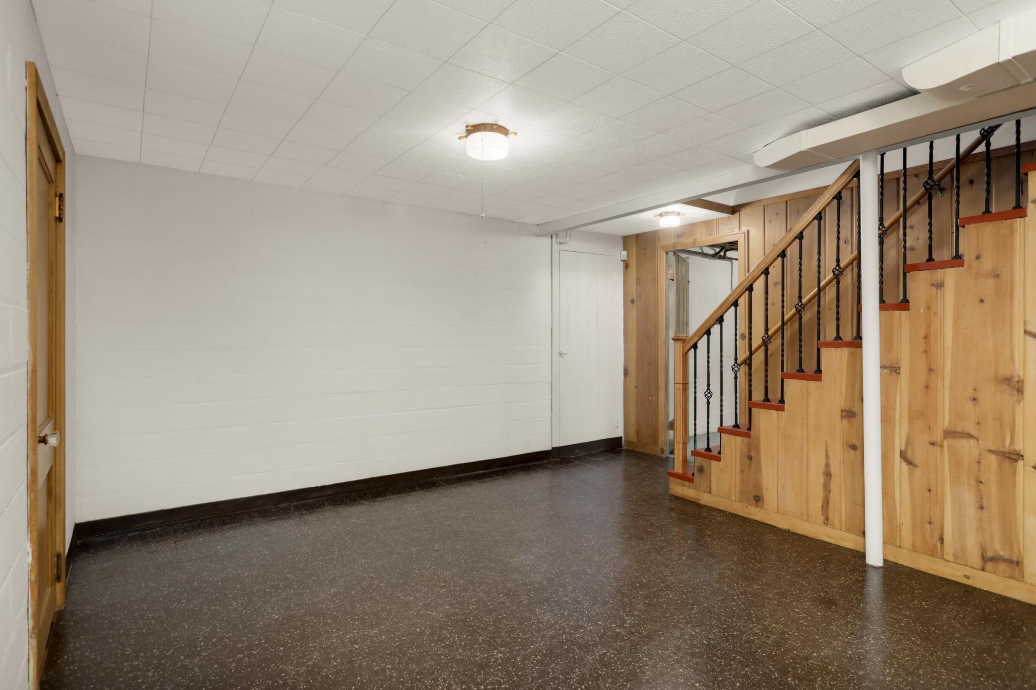Lower level family room has original woodwork and flooring.