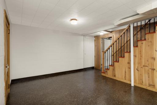 Lower level family room has original woodwork and flooring.