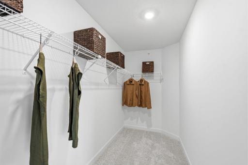 This oversized walk-in closet with built-in shelving optimizes wardrobe organization