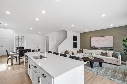 The multifunctional center island features an undermount stainless steel sink and a multi-cycle dishwasher