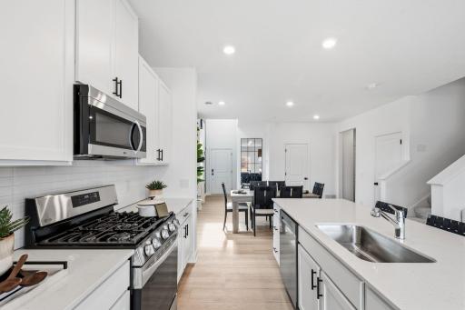 LED lighting at the center island illuminates the space in an elegant manner for food prep and other daily needs
