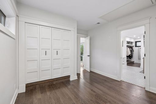 Primary suite offers excellent storage with separate his-and-hers closets.