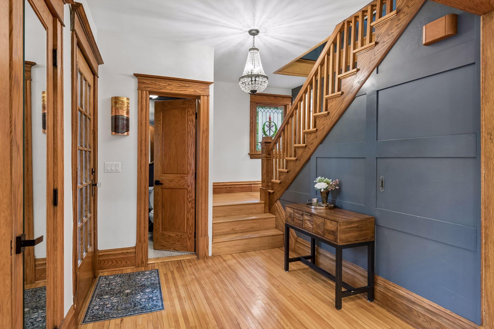 Welcoming entry showcasing original character alongside updated trim, doors and lighting.