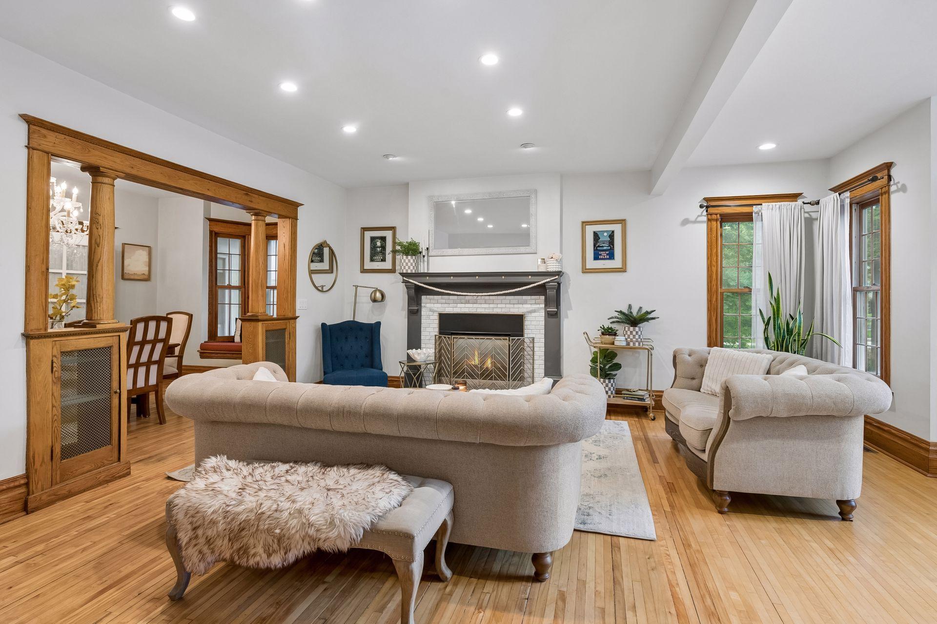 Light-filled living room with hardwood floors and beautifully updated fireplace.