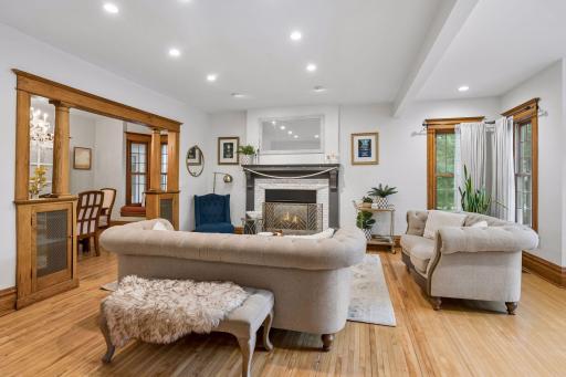 Light-filled living room with hardwood floors and beautifully updated fireplace.