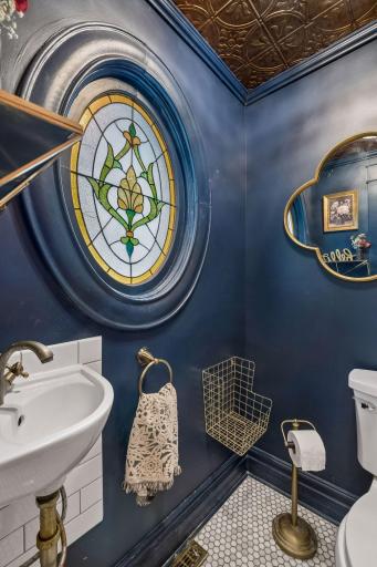 Main-level powder room adds personality with distinctive architectural details.