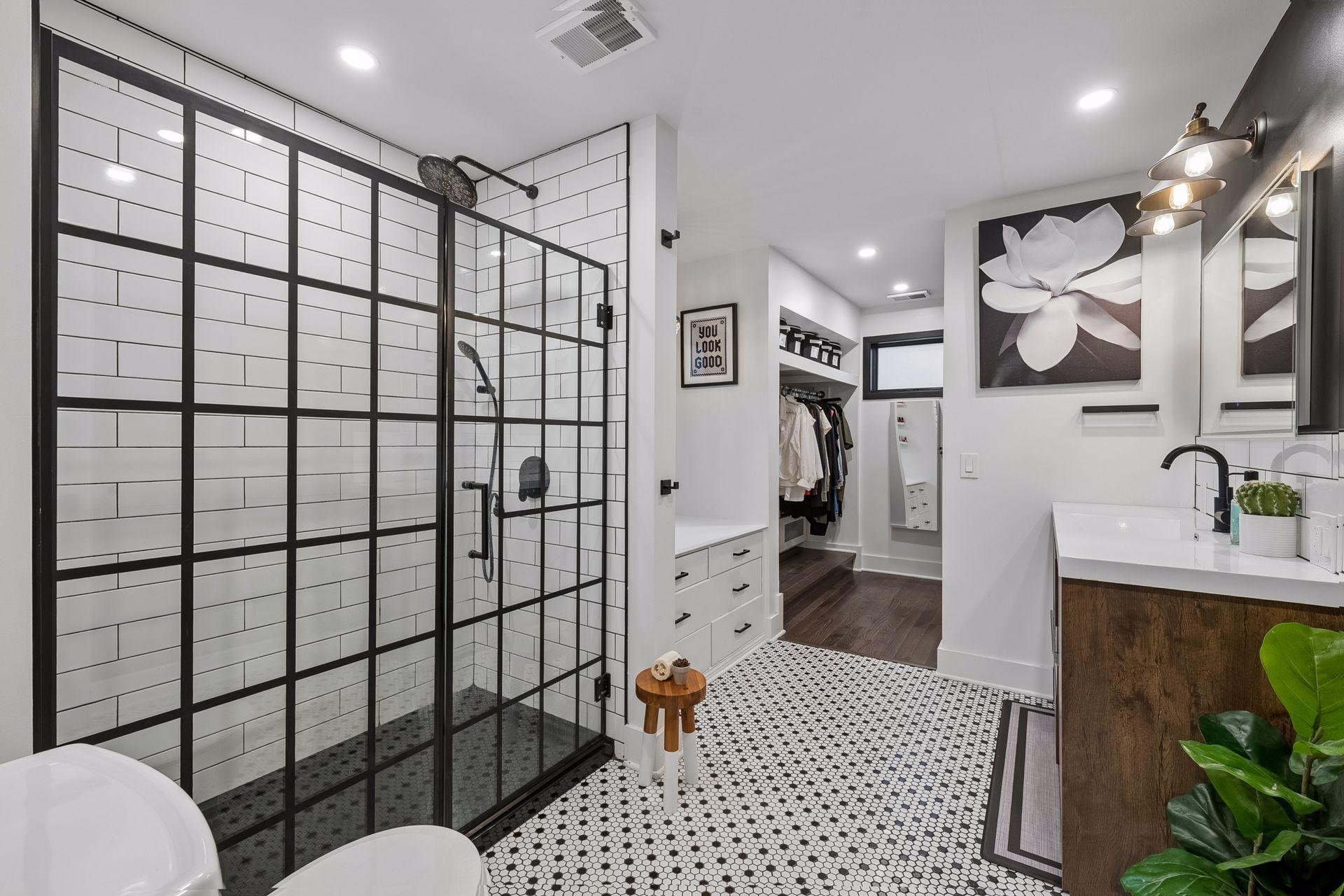 Updated primary bath features refreshed tile and a spacious walk-in shower.