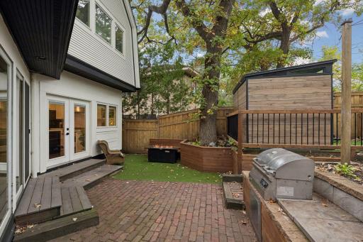 Cedar privacy fence, mature trees, create a remarkably private city backyard