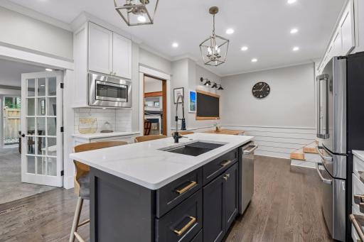 Large center island adds excellent workspace, storage and seating.