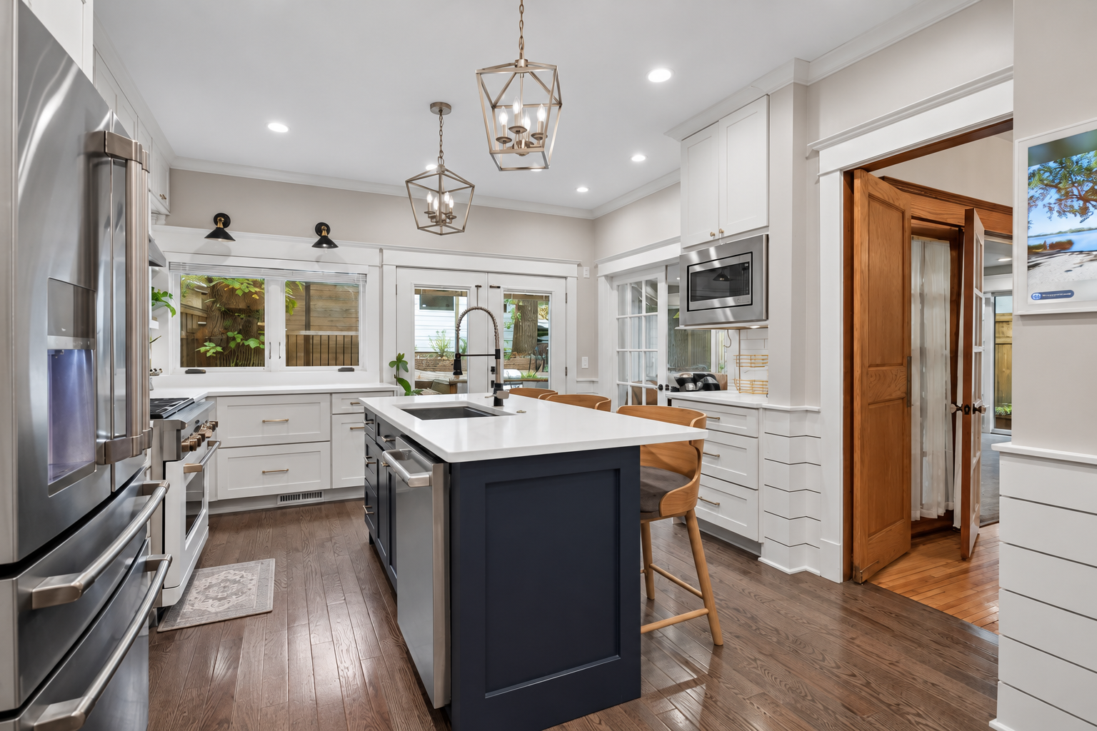 Beautifully renovated kitchen offers abundant cabinetry and generous prep space.