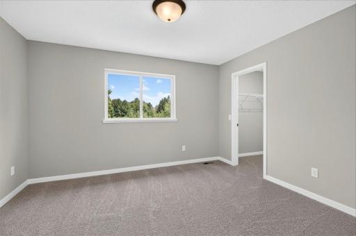 Bedroom 2. Photo taken of another home with similar plan and finishes.