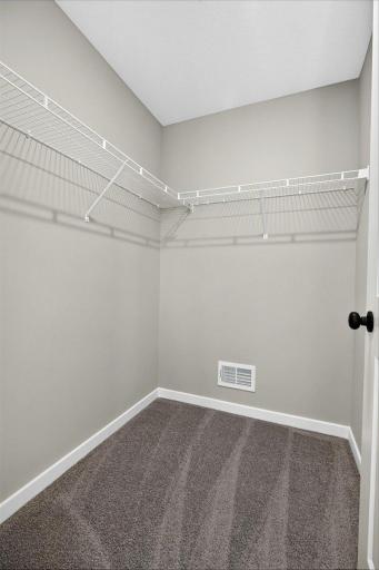 Primary Suite. Photo taken of another home with similar plan and finishes.