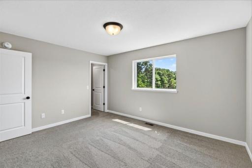 Primary Suite. Photo taken of another home with similar plan and finishes.