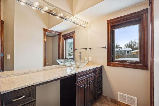 Primary bathroom featuring granite countertops and ample vanity space.