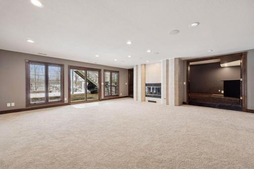 Step from the lower-level family room onto the patio and pool area while enjoying built-in surround sound, perfect for seamless indoor-outdoor living and entertaining.