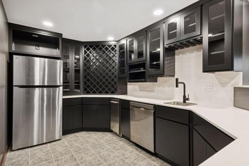 Enjoy a completely updated bar area with new cabinets and countertops, plus a built-in ice maker and dishwasher for convenience and style.