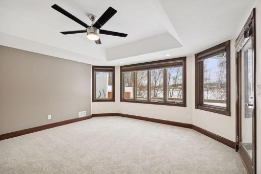 The lower-level bedroom walks out directly to the patio and pool, offering convenient outdoor access.