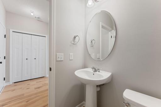 Convenient half bath with clean, modern finishes. Photo is for representational purposes only, not the actual home.