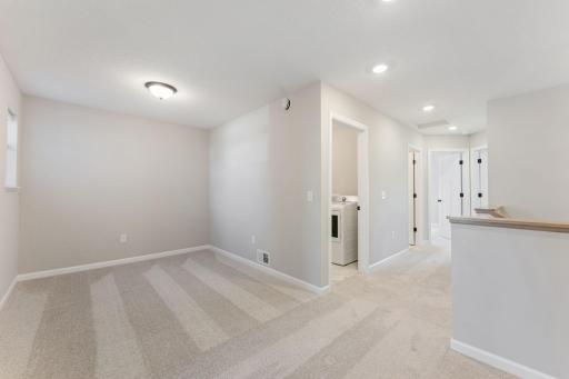 Versatile loft space perfect for relaxing, working, or entertaining. Photo is for representational purposes only, not the actual home.