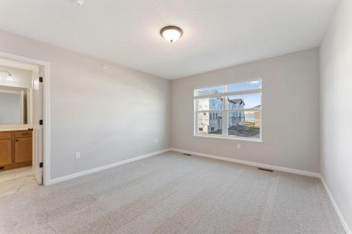 Spacious owner's suite offering a comfortable private retreat. Photo is for representational purposes only, not the actual home.