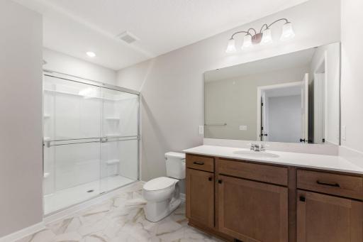 Private owner's bath with a thoughtful design. Photo is for representational purposes only, not the actual home.