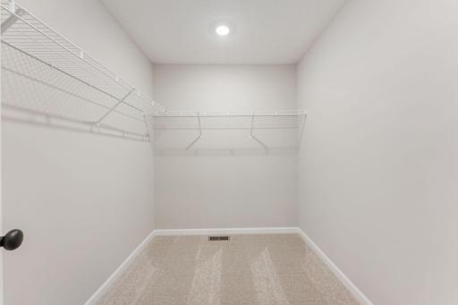 Generous walk-in closet with plenty of room for storage. Photo is for representational purposes only, not the actual home.