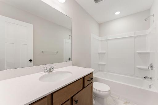 Full secondary bath conveniently located near the additional bedrooms. Photo is for representational purposes only, not the actual home.