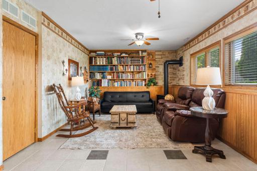 Lower level family room with gas burning fireplace stove, built-in bookshelves, look out windows