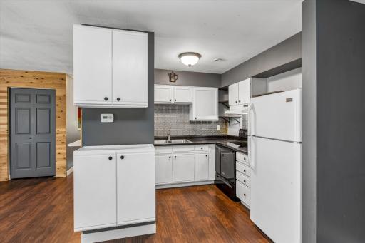 Kitchen with additional shelving that provides convenient storage for cookware, dishes, pantry items, and everyday essentials, helping keep countertops organized and making frequently used items easy to access.