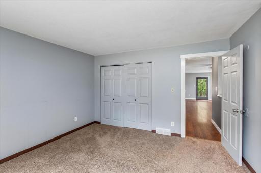 The main floor bedroom is filled with natural light, creating a bright, warm, and inviting space throughout the day.