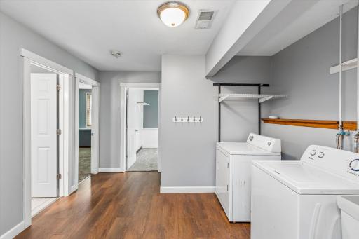 Another view of the laundry area. with the two bedrooms in the background.