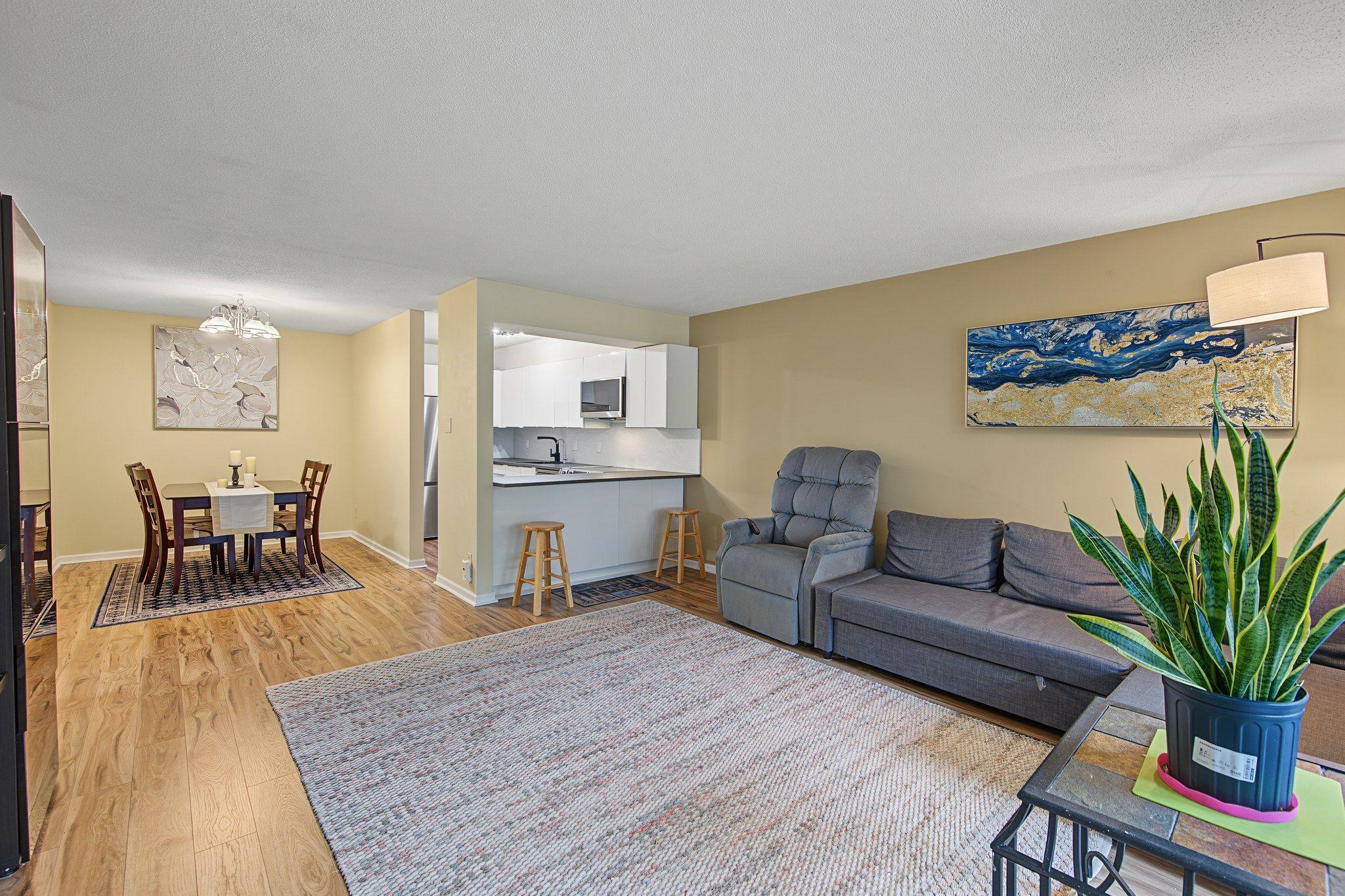 Kitchen with breakfast bar opens to the living room.