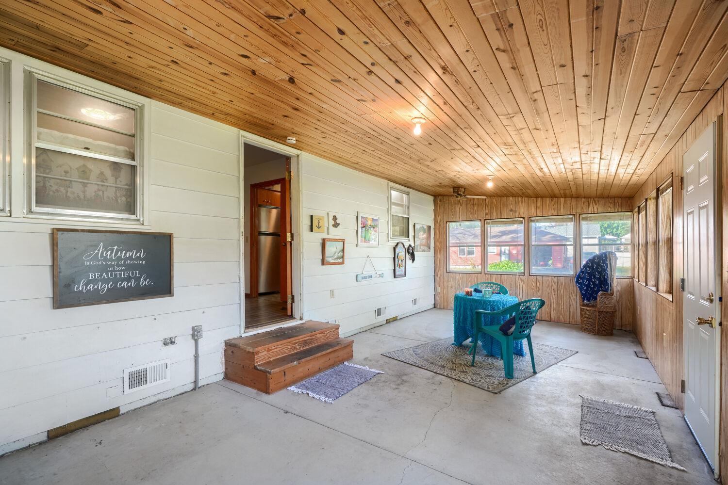HUGE porch reaching across entire back of home, Heat and A/C. Just insulate for potential additional bedroom or two!