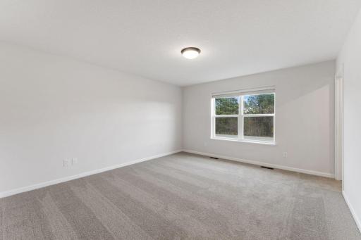Spacious owner's suite offering a comfortable private retreat. Photo is for representational purposes only, not the actual home.