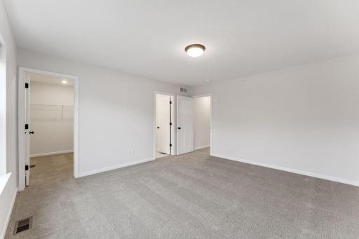 Spacious owner's suite offering a comfortable private retreat. Photo is for representational purposes only, not the actual home.