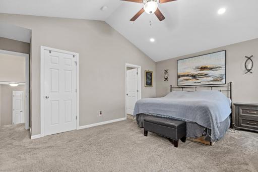 Primary suite with a walk-in closet and a full en-suite bath