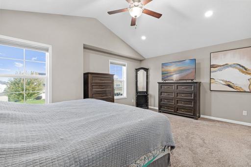 Vaulted ceilings and a primary filled with natural light