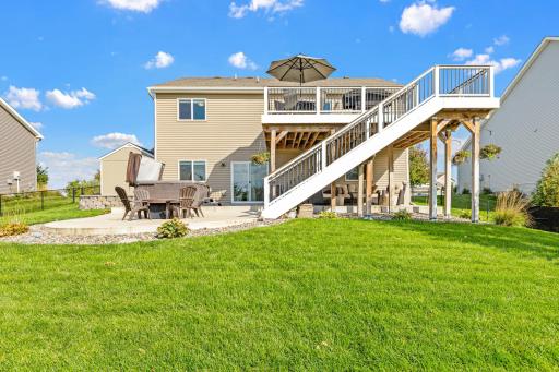 Outdoor living stretches from the Trex deck to the yard below with solar lighted stairs.