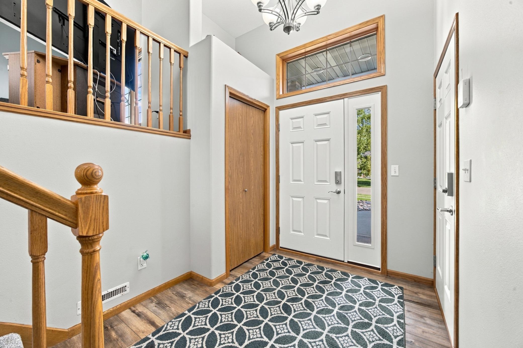 Front Foyer with updated LVP Flooring, New Front Door & Garage Service Door