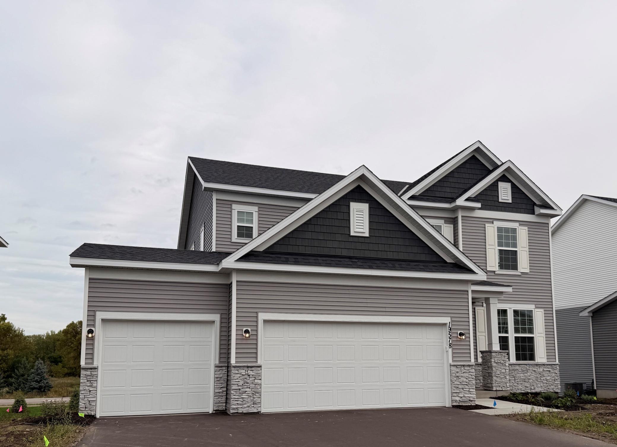 Welcome to your new home! Smooth, clean walkways guide visitors to the front door, bordered by tasteful landscaping that enhances the home’s inviting exterior.